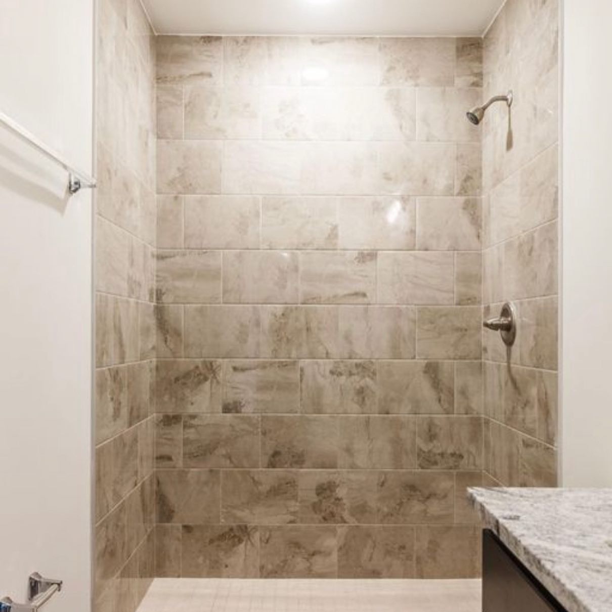 Walk-in shower with marbled tile