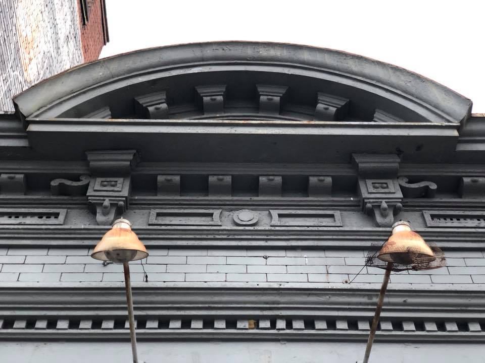 Arched pediment with dentil molding before renovation