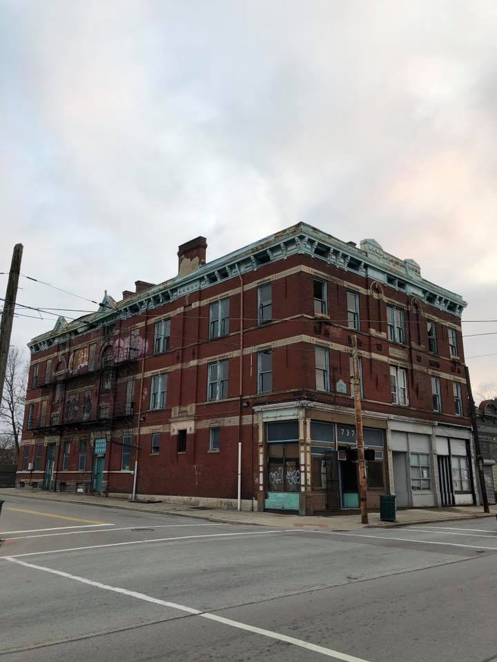 737 McMillan before renovation — derelict red brick corner building